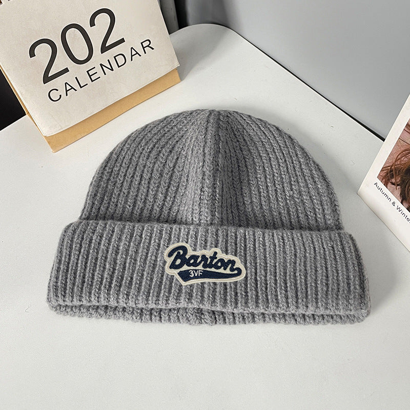 Winter letter labeling wool hat women's autumn and winter versatile warm Japanese knitted hat showing small face and ear protection cold hat man