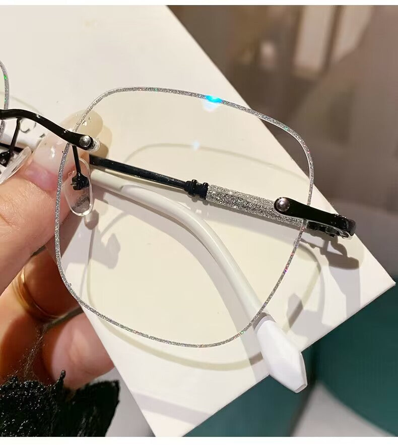 2023 fashion trendy frameless gold powder design high sense anti-blue glasses women's Internet celebrity flat glasses wholesale