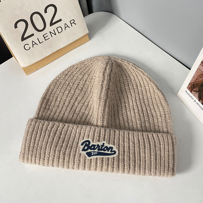 Winter letter labeling wool hat women's autumn and winter versatile warm Japanese knitted hat showing small face and ear protection cold hat man